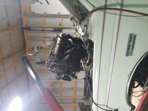 1989 Ford Bronco - Engine removal in progress, showing the vehicle's side and interior mechanics.