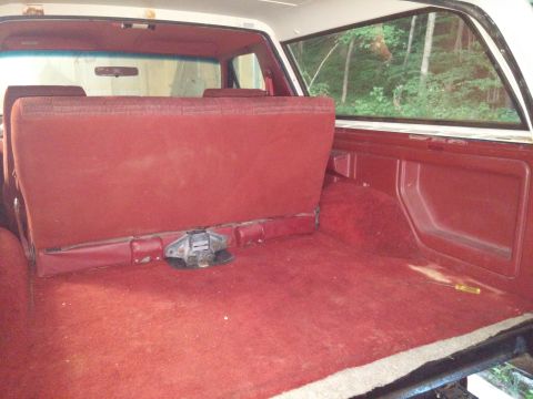 1989 Ford Bronco - Rear interior view of a 1989 Ford Bronco, showing the cargo space and rear seat.