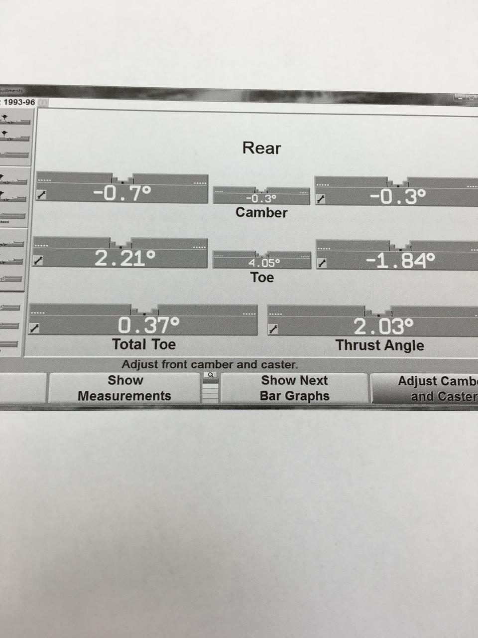 Wheel alignment readout showing rear camber and toe measurements, plus total toe and thrust angle