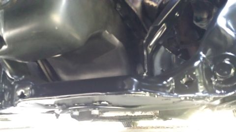 1980 Ford Mustang - A close-up view of the underside of a vehicle, showing suspension components and the exhaust system.