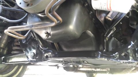 1980 Ford Mustang - Underside view shows the engine oil pan, suspension, and an oil filter. The year is not discernible.