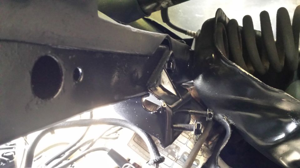 Black suspension part with coil spring and mounting bolts