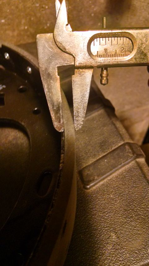 1994 Ford Bronco - Measuring brake shoe thickness with a caliper.