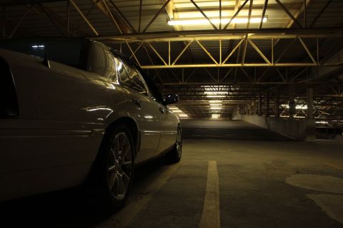 2000 Mercury Grand Marquis - Side view of a 2000 Mercury Grand Marquis in a parking garage with overhead lights.