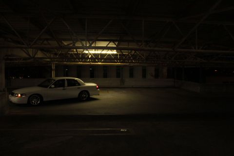 2000 Mercury Grand Marquis - White 2000 Mercury Grand Marquis parked inside a large structure with exposed beams.