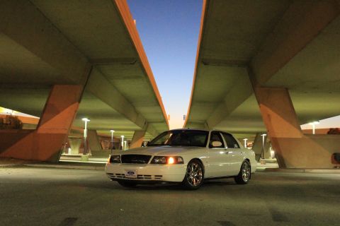 2000 Mercury Grand Marquis - White 2000 Mercury Grand Marquis parked under a concrete overpass at dusk.