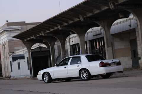 2000 Mercury Grand Marquis - White 2000 Mercury Grand Marquis parked on pavement under a concrete overpass.