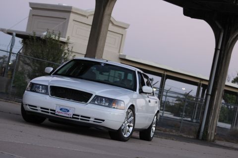 2000 Mercury Grand Marquis - A white 2000 Mercury Grand Marquis sedan is parked outdoors, with a Ford Racing license plate visible on the front.