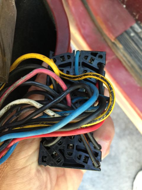 1989 Ford Bronco - A close-up view of a tangled vehicle wiring harness with multiple colored wires and connectors.