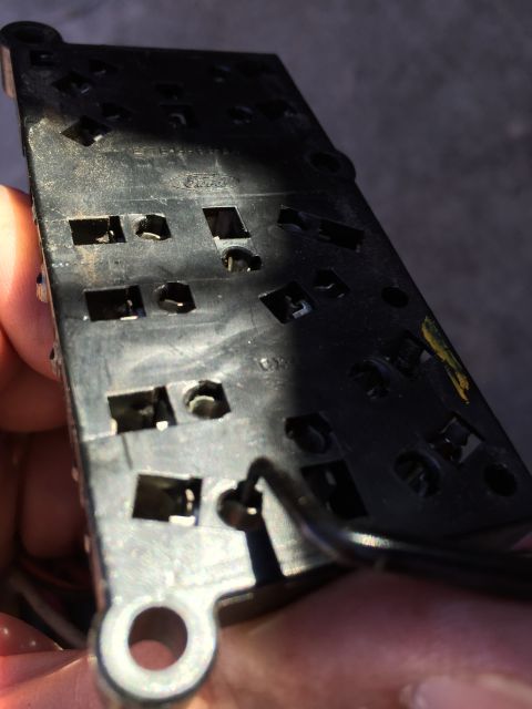 1989 Ford Bronco - Close-up of a window lock switch assembly, likely an interior car part.