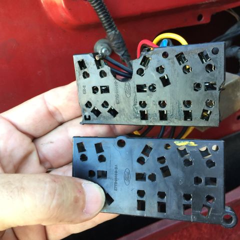1989 Ford Bronco - Comparing two Ford window lock switch assemblies, part numbers E7TB-14A469-BA and E7TB-14A469-CA are visible.