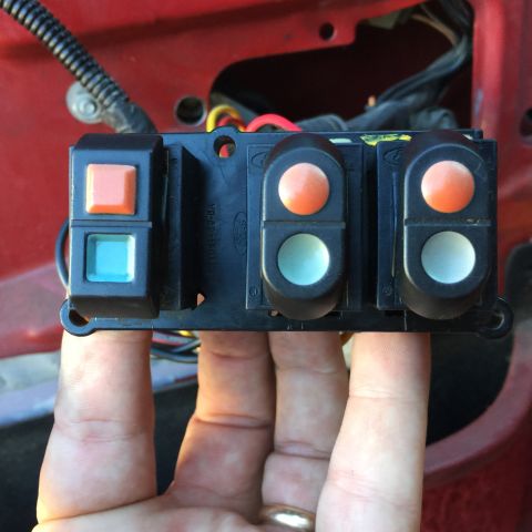 1989 Ford Bronco - Ford window switch assembly with multiple buttons, likely for power windows and locks.