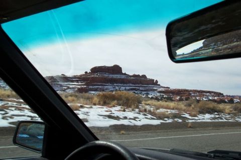 1990 Ford Bronco - Driving through a snowy desert landscape, as seen from inside the vehicle.