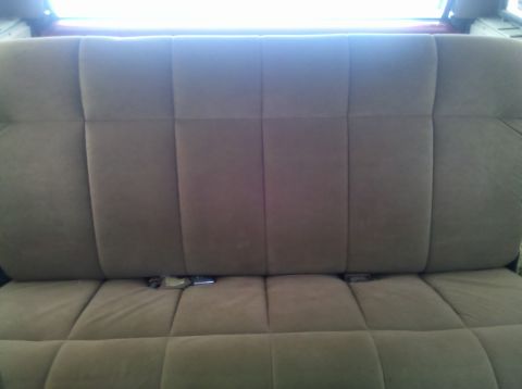 1990 Ford Bronco - Rear bench seat interior view, seatbelts are visible.