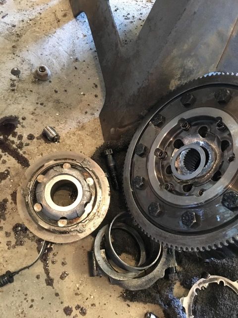 1996 Ford Bronco - Close-up of differential gears and associated parts scattered on a workshop floor.