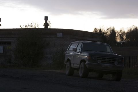 1987 Ford Bronco - A 1987 Ford Bronco is seen from the front-right angle under an overcast sky.