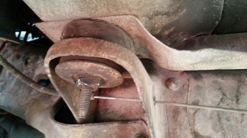 1981 Ford Bronco - Underside view of a vehicle's frame mount showing a rubber bushing and bolt assembly.