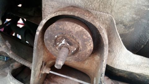 1981 Ford Bronco - This image shows a worn suspension bushing, a part of a vehicle's undercarriage.