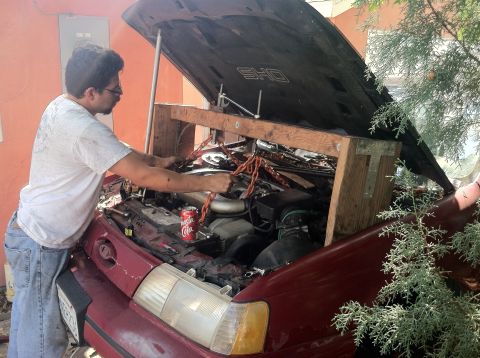1993 Ford Taurus - Working on the engine of a 1993 Ford Taurus with a makeshift support system.