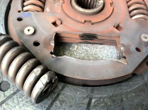 1993 Ford Taurus - A damaged clutch pressure plate shows broken springs and bent metal components.