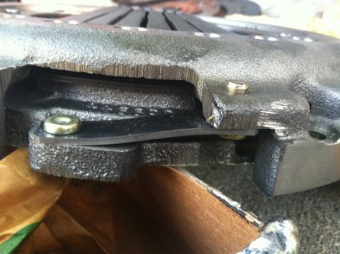 1993 Ford Taurus - A damaged clutch pressure plate shows signs of wear and tear, with visible text stamped into the metal.