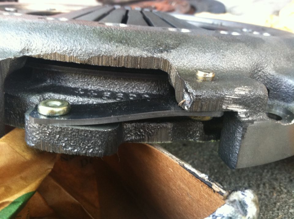 Close-up of a damaged clutch pressure plate with visible text