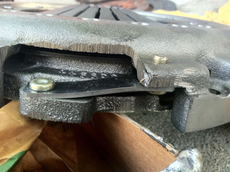 Close-up of a clutch pressure plate with visible wear and damage