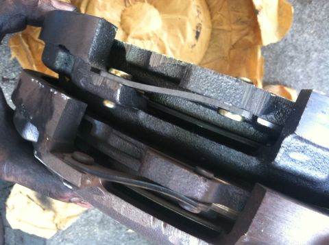 1993 Ford Taurus - A close-up view of a brake caliper and pads, possibly for replacement or inspection.