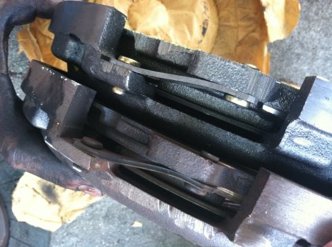 1993 Ford Taurus - A close-up view of a brake caliper, showing the brake pads and internal mechanisms.