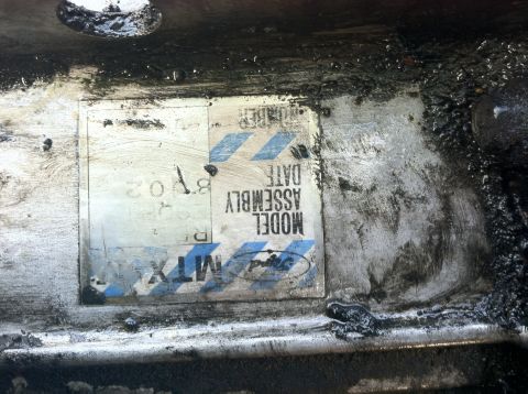 1993 Ford Taurus - A close-up of a metal plate with assembly information, including the text "MTX" and a Ford logo.