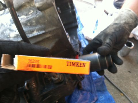 1993 Ford Taurus - A Timken bearing box with part number 3622S is held near a metal component.