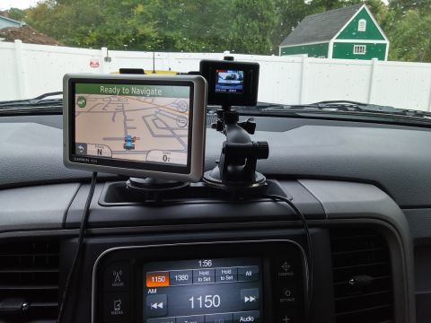 2000 Ford Crown Victoria - Interior view of a vehicle's dashboard a GPS navigation system and a dashcam.