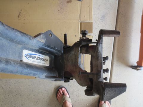 1996 Ford Bronco - A close-up view of a Pro Comp suspension system part, likely from a 1996 Ford Bronco, showing bolted components and a sticker. The part is…