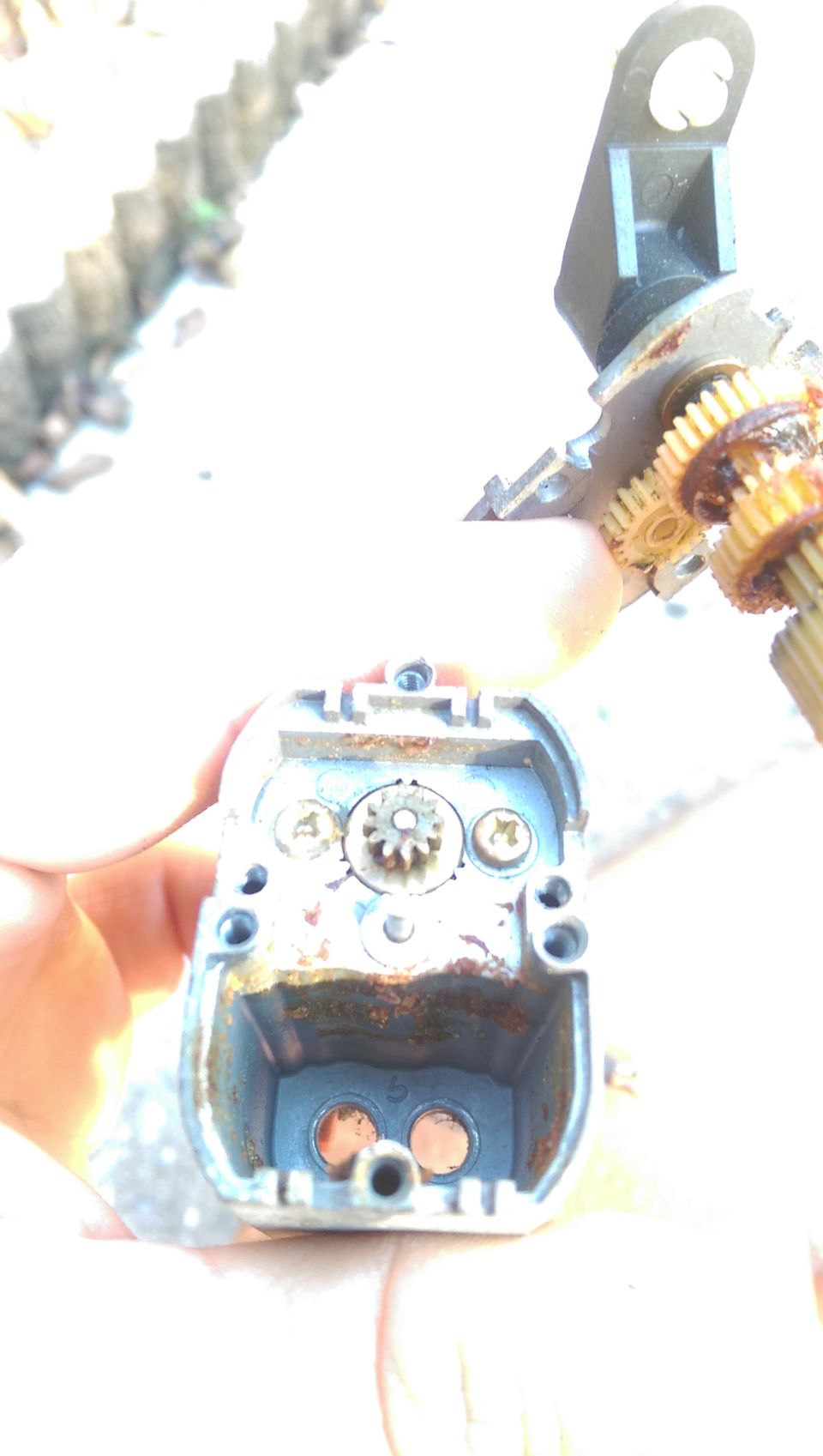 Disassembled automotive component with rusted gears