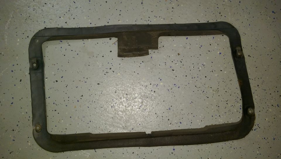 Black rubber gasket with metal reinforcement and mounting holes