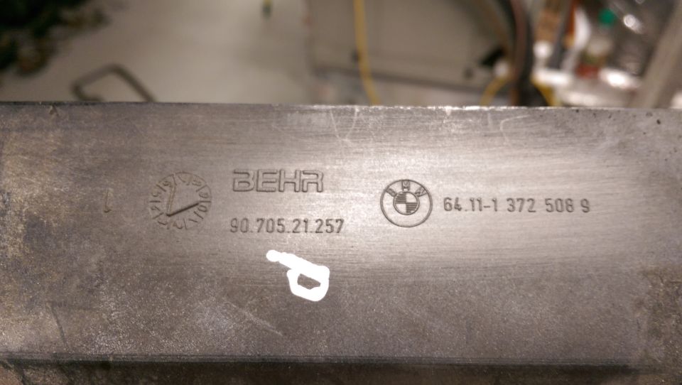 Metal part with BEHR and BMW logos and part numbers