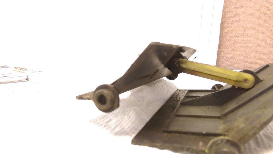 Close-up of HVAC lever mechanism with yellow rod, resting on paper towel.
