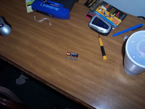 1990 Ford Bronco - A collection of electronic devices and tools are scattered across a wooden desk surface.