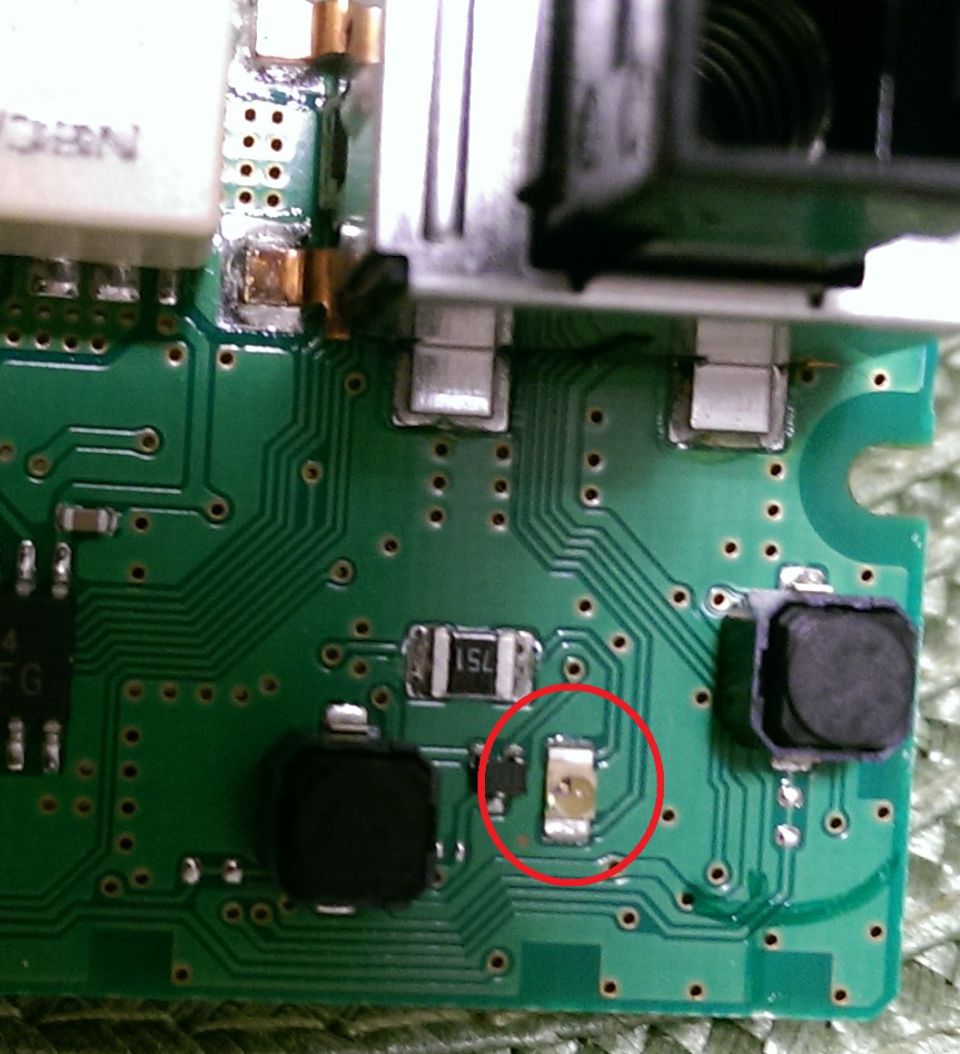 Close-up of a circuit board with electronic components, highlighted by a red circle.
