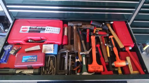 1994 Ford Bronco - A drawer full of tools, including various hammers, a tap and die set, and a rear axle bearing puller set.