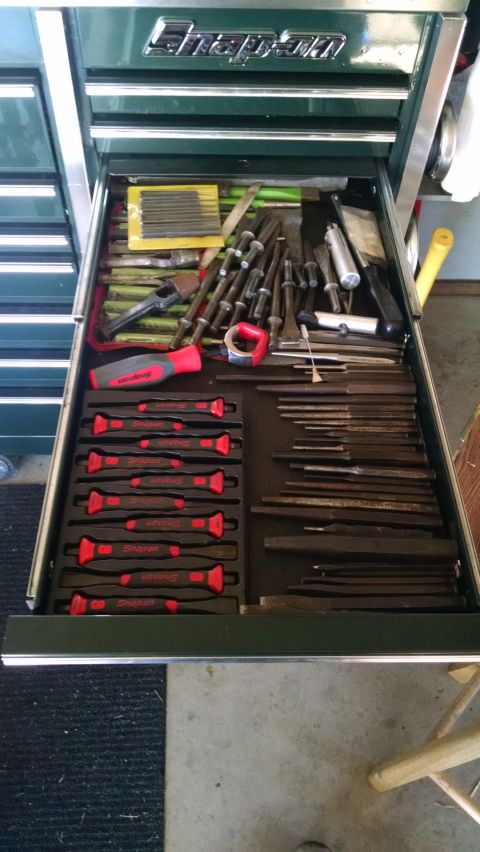 1994 Ford Bronco - An open toolbox drawer filled with various hand tools, including punches, chisels, files, and screwdrivers. The tools are neatly organized…