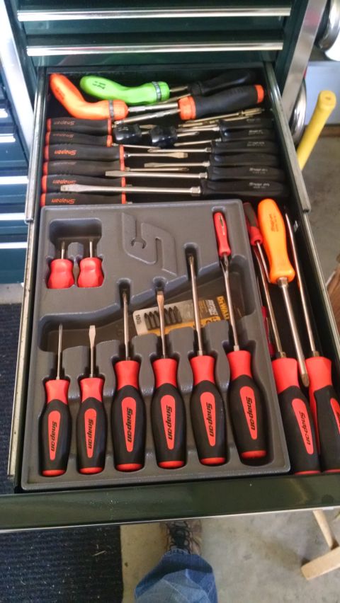 1994 Ford Bronco - A drawer of a mechanic's tool chest is filled with various screwdrivers. The screwdrivers have black and red handles, with some featuring o…