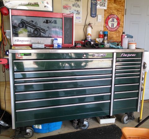 1994 Ford Bronco - A dark green Snap-on toolbox with an F-150 logo is shown in a garage setting. The toolbox has multiple drawers and is equipped with wheels…