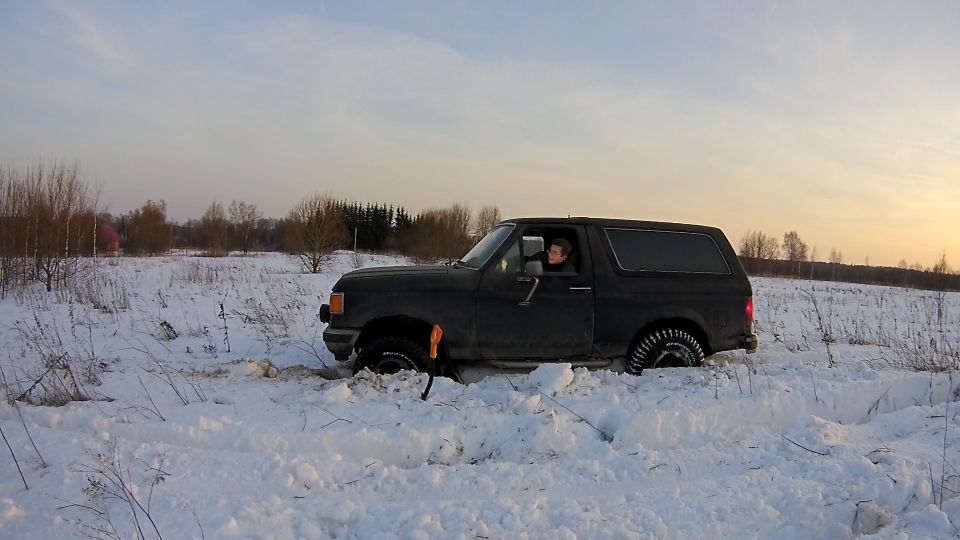 Dark SUV stuck in snow with driver