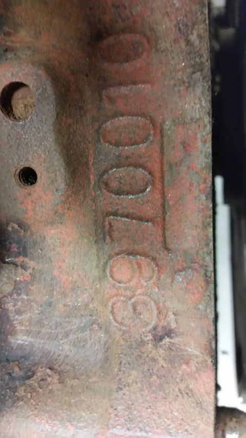 2015 Chevrolet new - A close-up view of a cast iron part with stamped numbers "3970010". The part is red and shows signs of rust and wear.