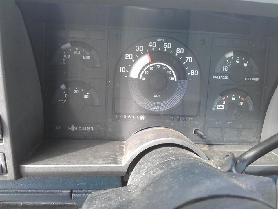 Vehicle dashboard with speedometer, fuel gauge, temperature gauge, oil pressure gauge, and odometer reading 315610.