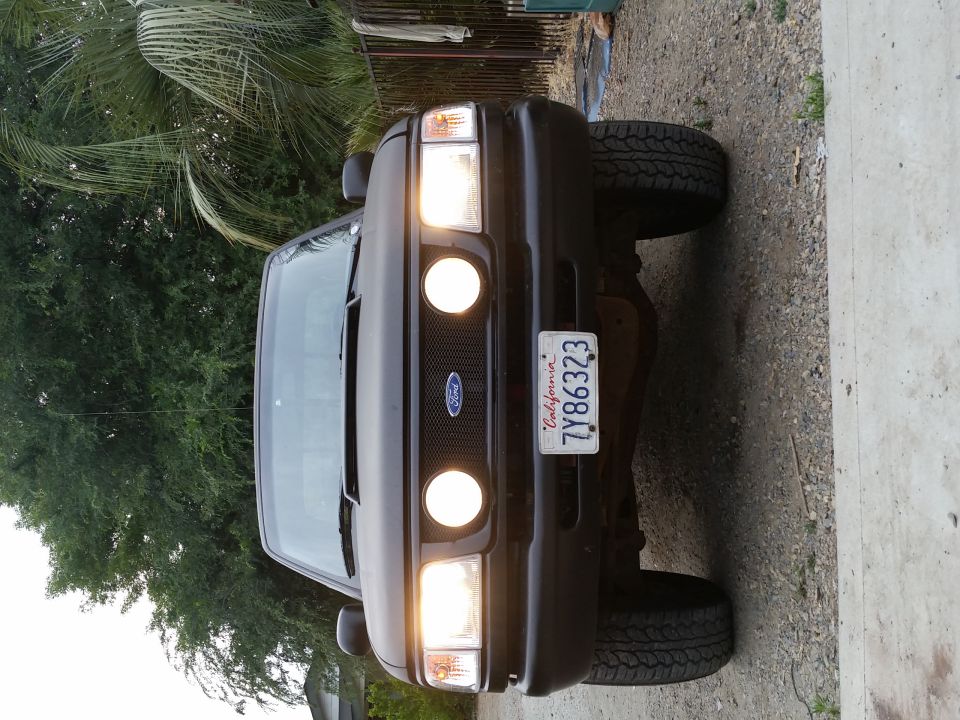 Front view of a dark Ford truck with California license plate 7Y86323