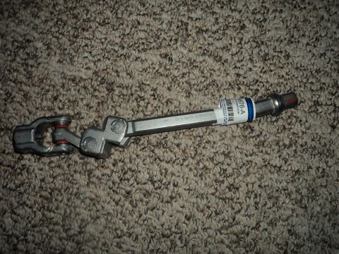 2004 Mercury Grand Marquis - A steering column intermediate shaft is shown lying on a carpeted surface.