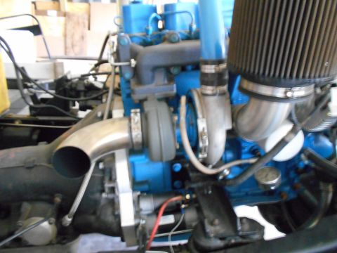1992 Ford Bronco - Close-up view of a turbocharged engine, blue paint and various hoses and pipes.