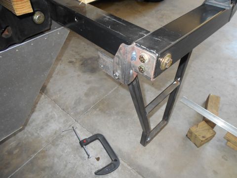 1992 Ford Bronco - A close-up view of a custom metal frame assembly, possibly for a vehicle modification, with tools present.